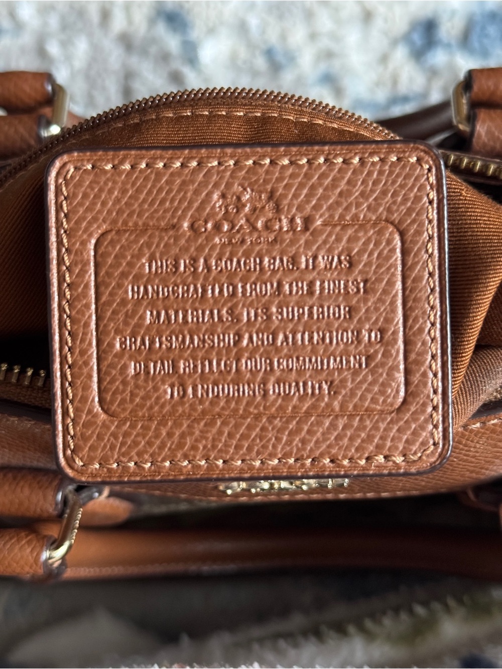 Coach women’s  Tan Leather Crossbody Bag with Embossed Logo Patch